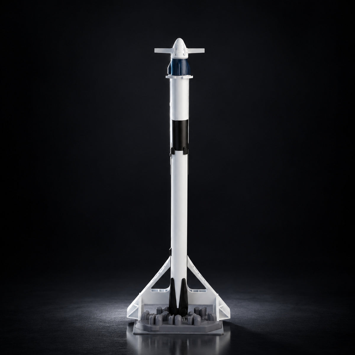 Falcon 9 scale model on a dark studio background
