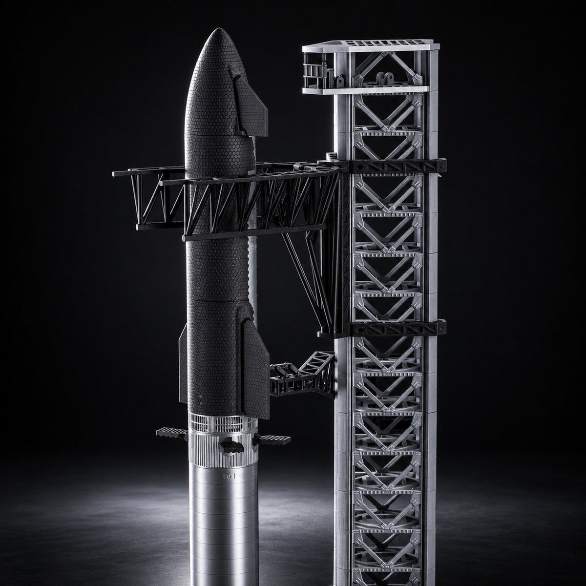 Starship bundle with launch tower scale model on a dark studio background
