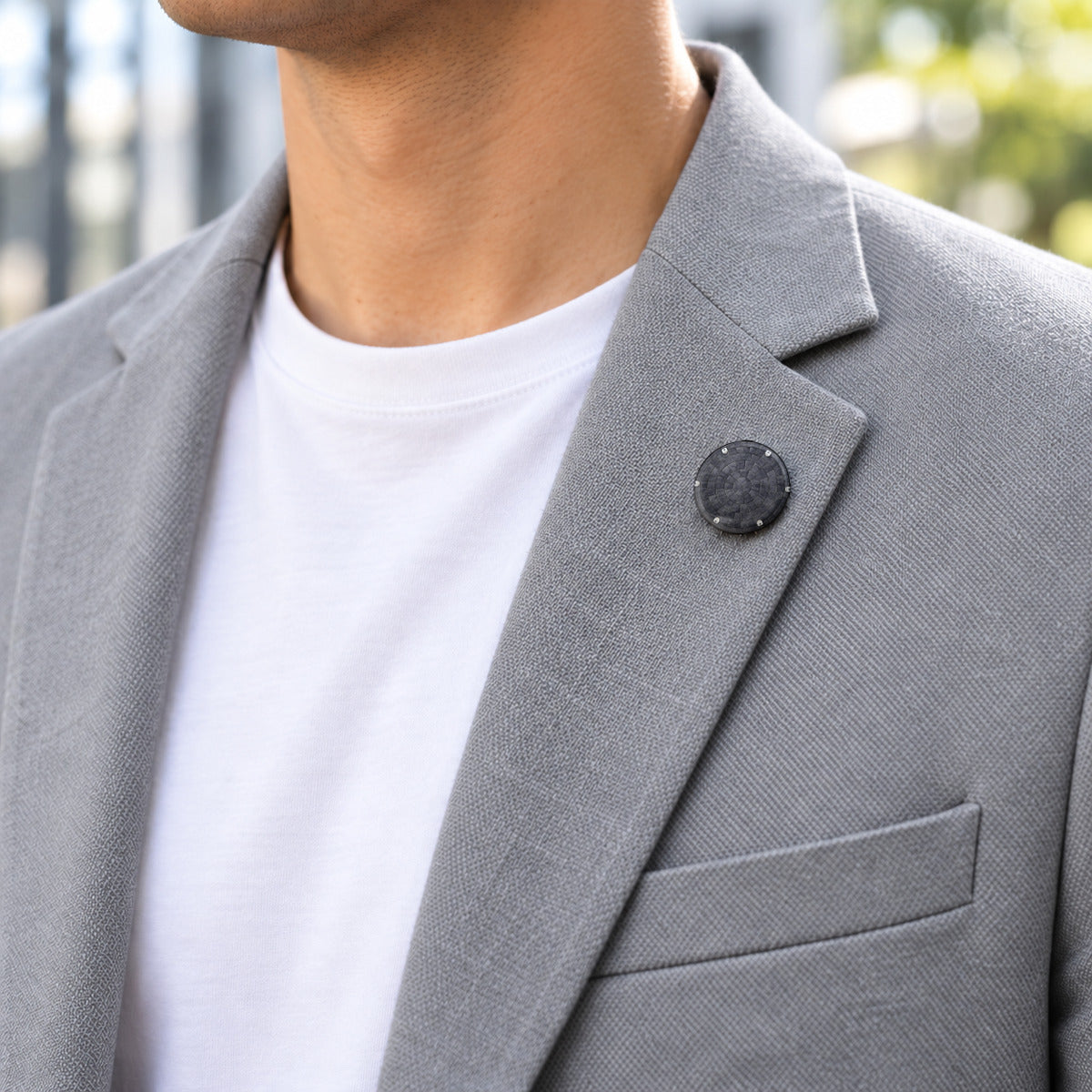 Orion heat shield 25 mm pin on the lapel of a grey casual blazer