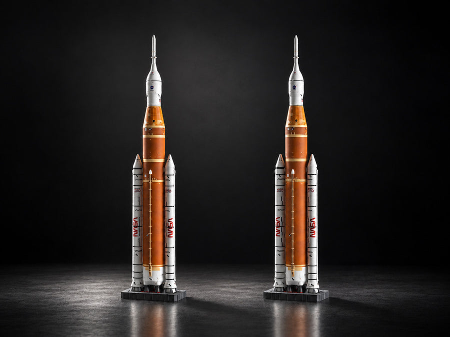 Two SLS 1:144 models side by side on the same floor, lit by one key light from the left