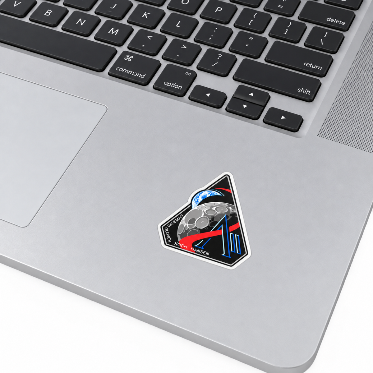 Artemis II mission badge vinyl sticker applied on a MacBook palm rest
