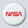 Round 25 mm pin with the red NASA worm logotype on a white face