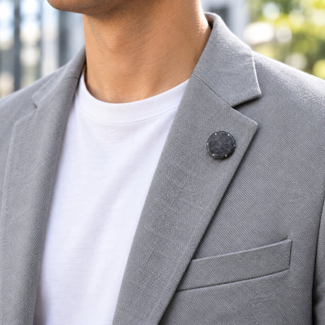 Orion heat shield 25 mm pin on the lapel of a grey casual blazer