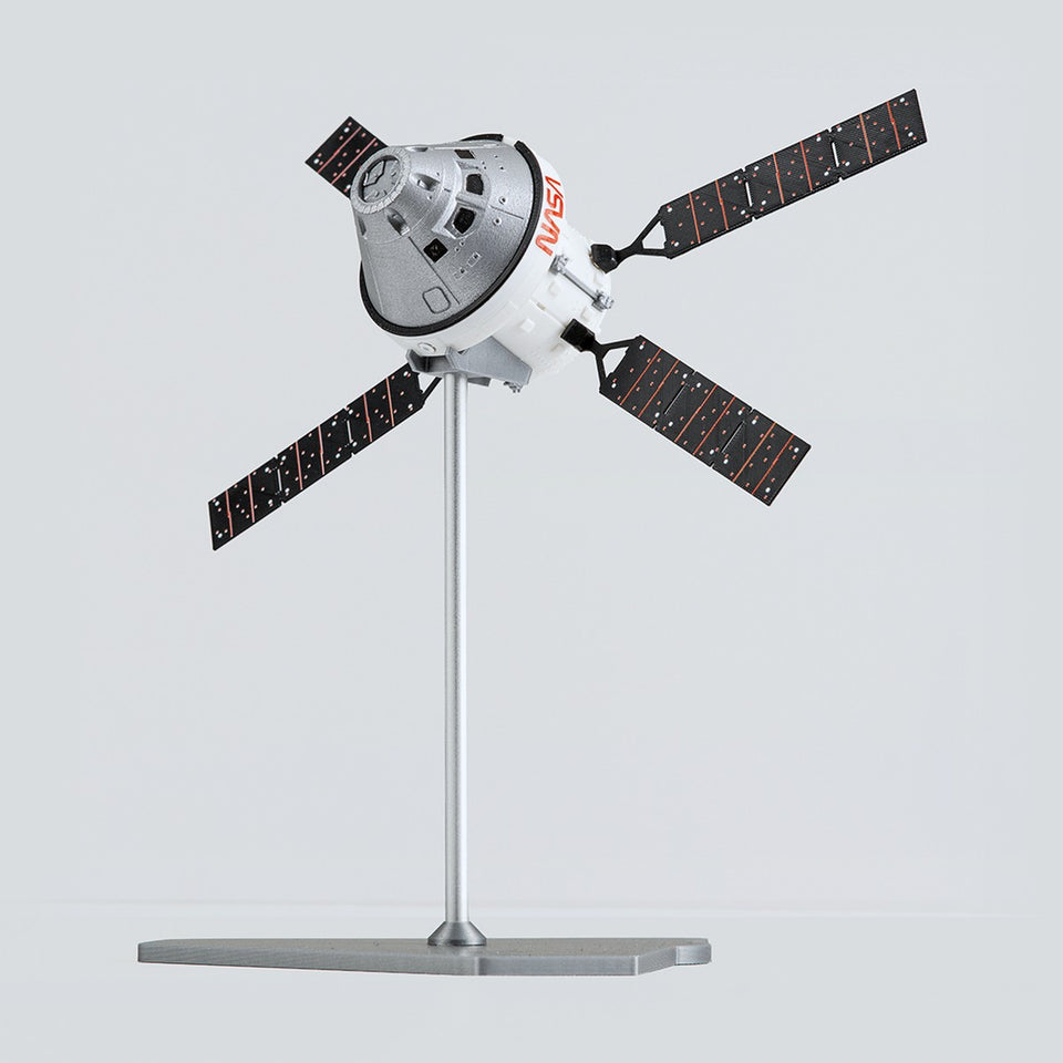 Orion with the European Service Module and four solar arrays on a display stand, three-quarter view